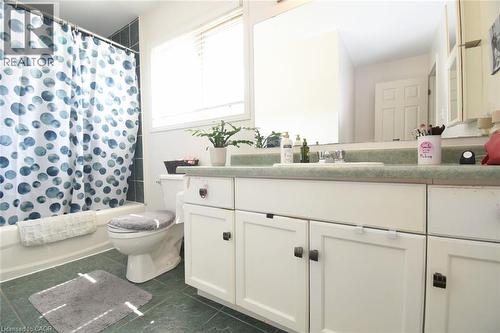 White vanity with integrated sink, expansive vanity mirror, and white cabinetry with dark hardware - 509 Southridge Drive, Hamilton, ON - Indoor Photo Showing Bathroom