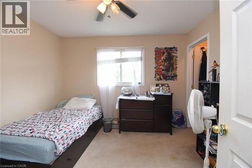 Neutral tone wall paint, carpet flooring, window with white blinds, and a ceiling fan with light fixture - 509 Southridge Drive, Hamilton, ON - Indoor Photo Showing Bedroom