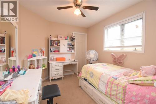 Recessed window with white blinds and trim, light beige walls, ceiling fan with integrated lighting, and a white interior door - 509 Southridge Drive, Hamilton, ON - Indoor Photo Showing Bedroom