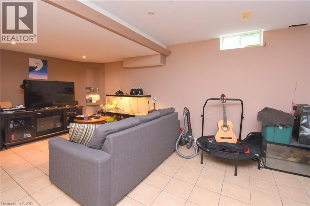 Recessed ceiling lighting, tiled flooring, built-in shelving, and a wall-mounted electronic fireplace - 509 Southridge Drive, Hamilton, ON - Indoor