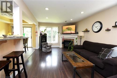 Wood-finish flooring throughout, featuring recessed lighting and a fireplace with a white mantel - 509 Southridge Drive, Hamilton, ON - Indoor Photo Showing Living Room With Fireplace