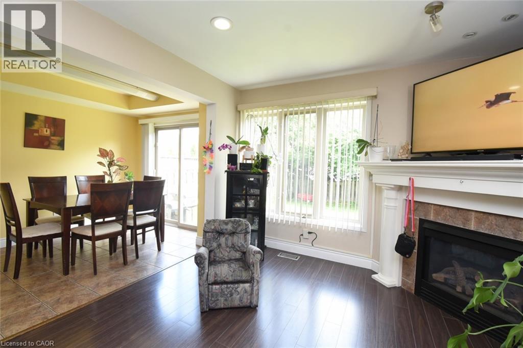 Fireplace and large windows and sliding patio door to outside fully fenced backyard. - 509 Southridge Drive, Hamilton, ON - Indoor With Fireplace