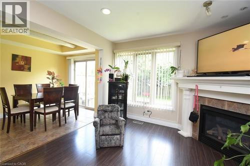Fireplace and large windows and sliding patio door to outside fully fenced backyard. - 509 Southridge Drive, Hamilton, ON - Indoor With Fireplace