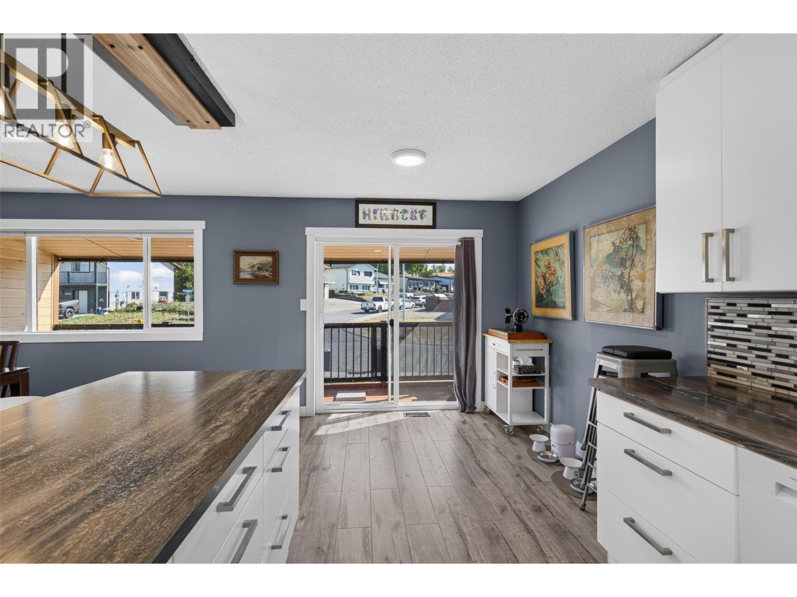 Sliding doors off the kitchen lead to the covered deck. - 3703 Commonage Crescent, Vernon, BC - Indoor