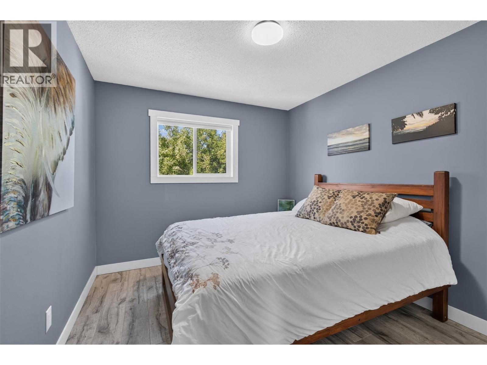 Bright and comfortable bedroom offering flexible living space. - 3703 Commonage Crescent, Vernon, BC - Indoor Photo Showing Bedroom
