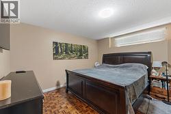 Downstairs Master Bedroom. Recessed window with horizontal blinds, wood-finish flooring, and neutral wall tones -