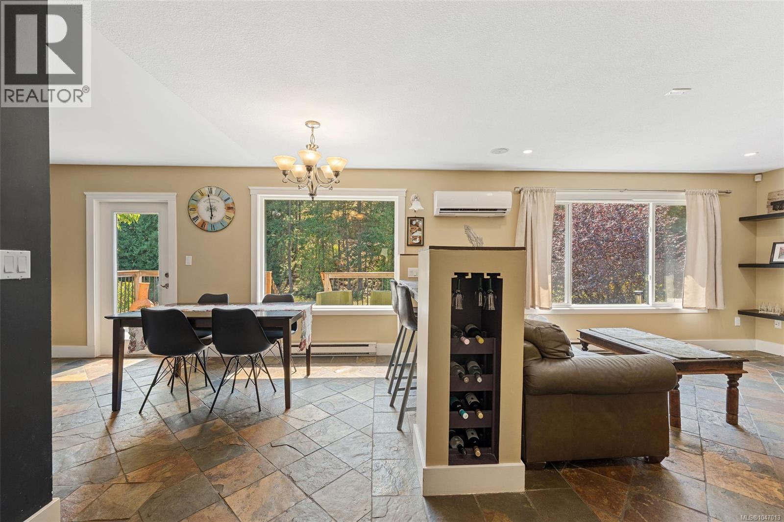 As you enter the kitchen, dining and living room you are greeted with lots of windows and natural light. - 4105 Ross Rd, Nanaimo, BC - Indoor