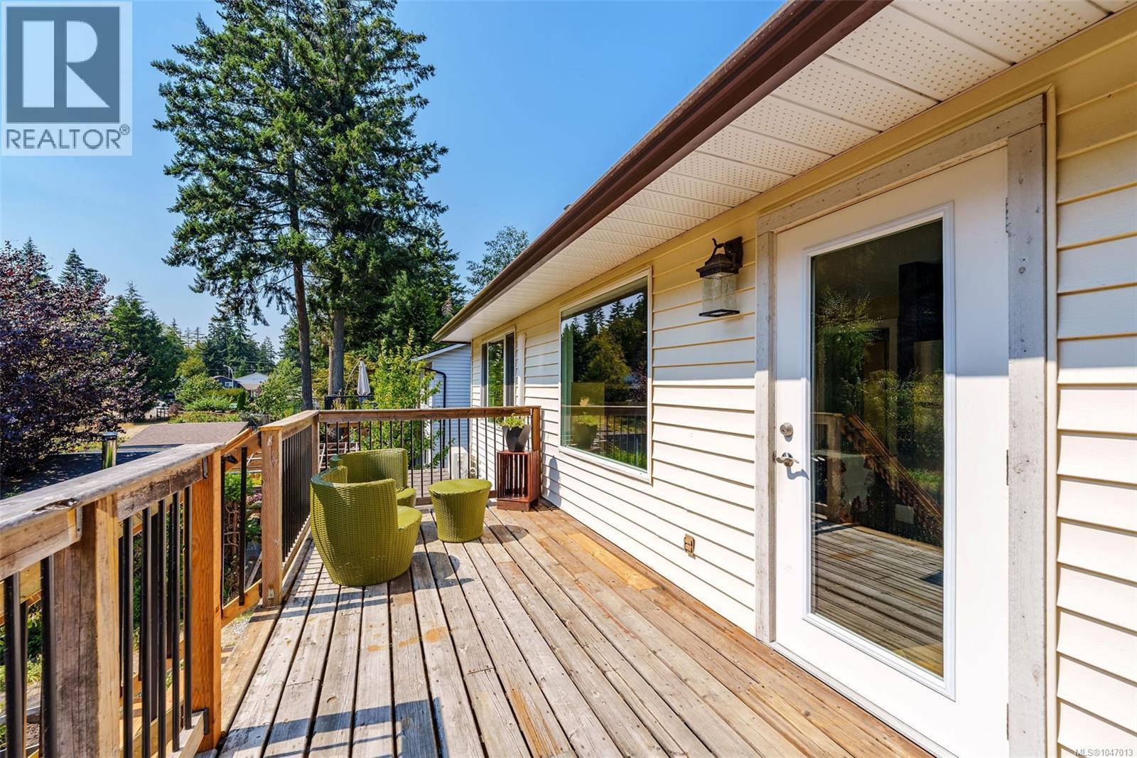 Wood deck with access to brand new stairs, full-light door, and exterior sconce. Perfect place for your morning coffee. - 4105 Ross Rd, Nanaimo, BC - Outdoor With Deck Patio Veranda With Exterior