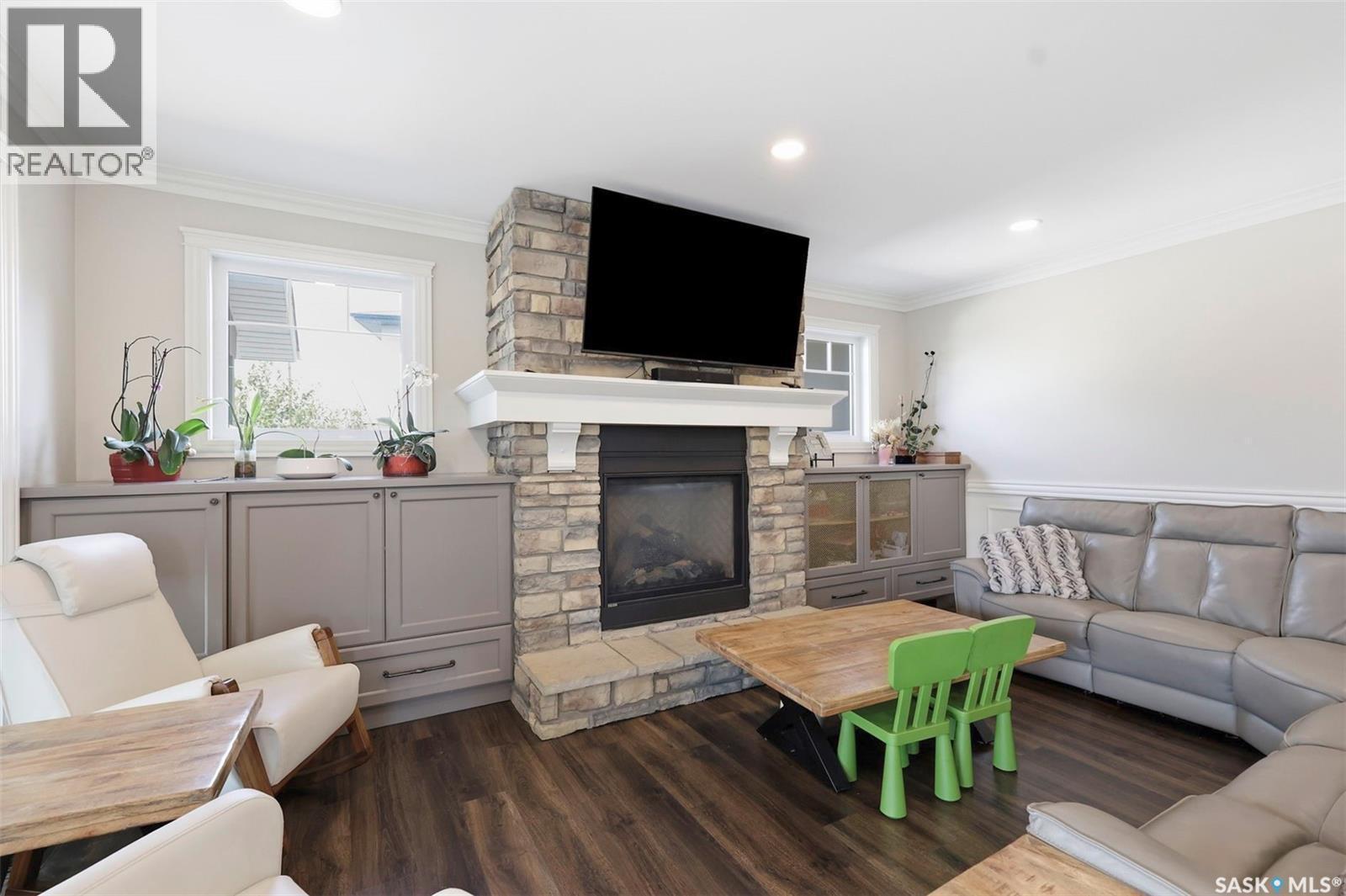 419 Salloum Bay, Saskatoon, SK - Indoor Photo Showing Living Room With Fireplace