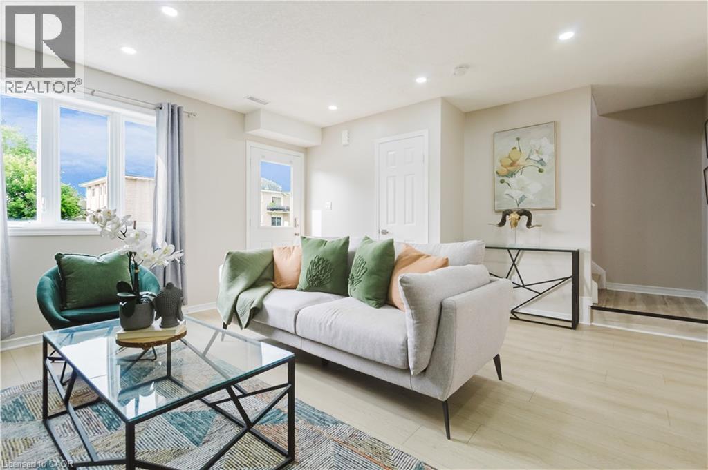 Recessed lighting, light wood-finish flooring, white trim, and a white door - 67 Kinzie Avenue, Kitchener, ON - Indoor Photo Showing Living Room