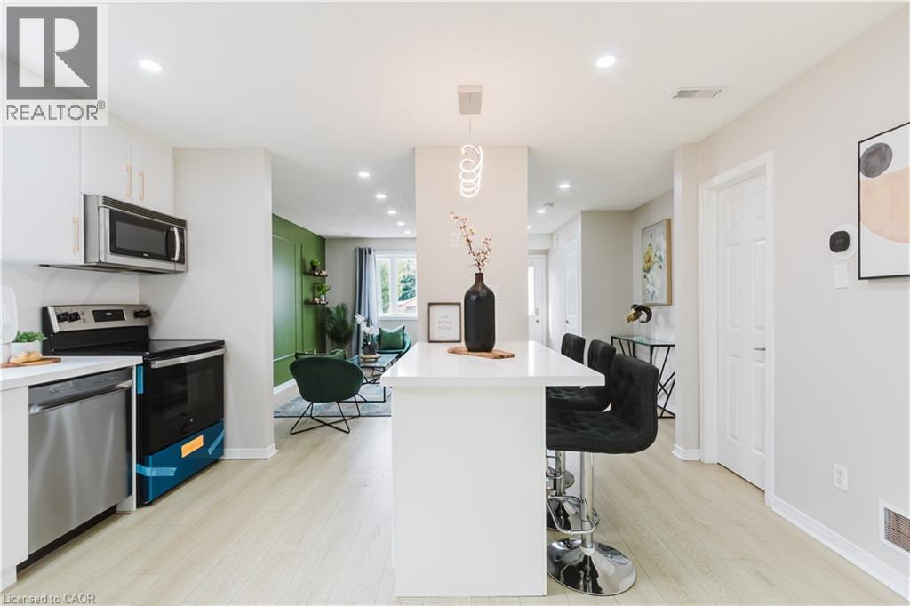 Modern kitchen with white cabinetry and stainless steel appliances - 67 Kinzie Avenue, Kitchener, ON - Indoor Photo Showing Kitchen