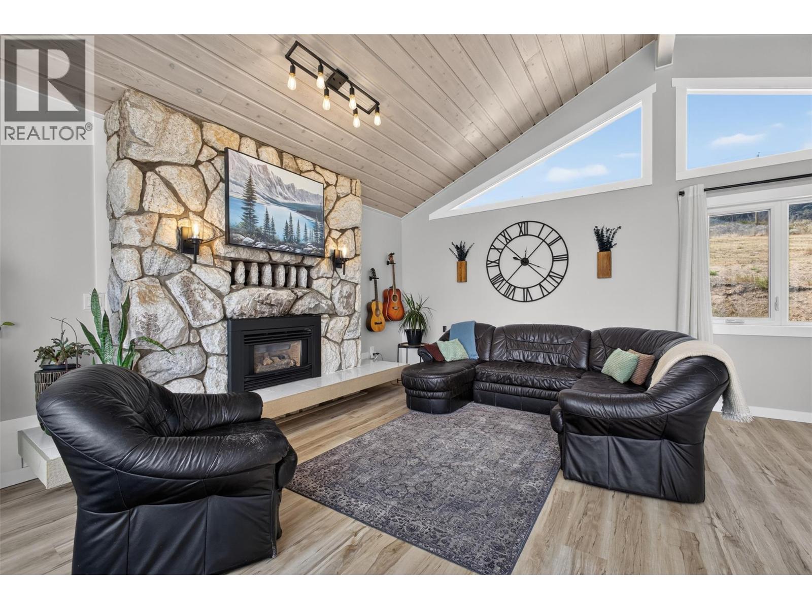 Vaulted ceilings with lots of large windows - 3491 Fenton Road, West Kelowna, BC - Indoor Photo Showing Living Room With Fireplace