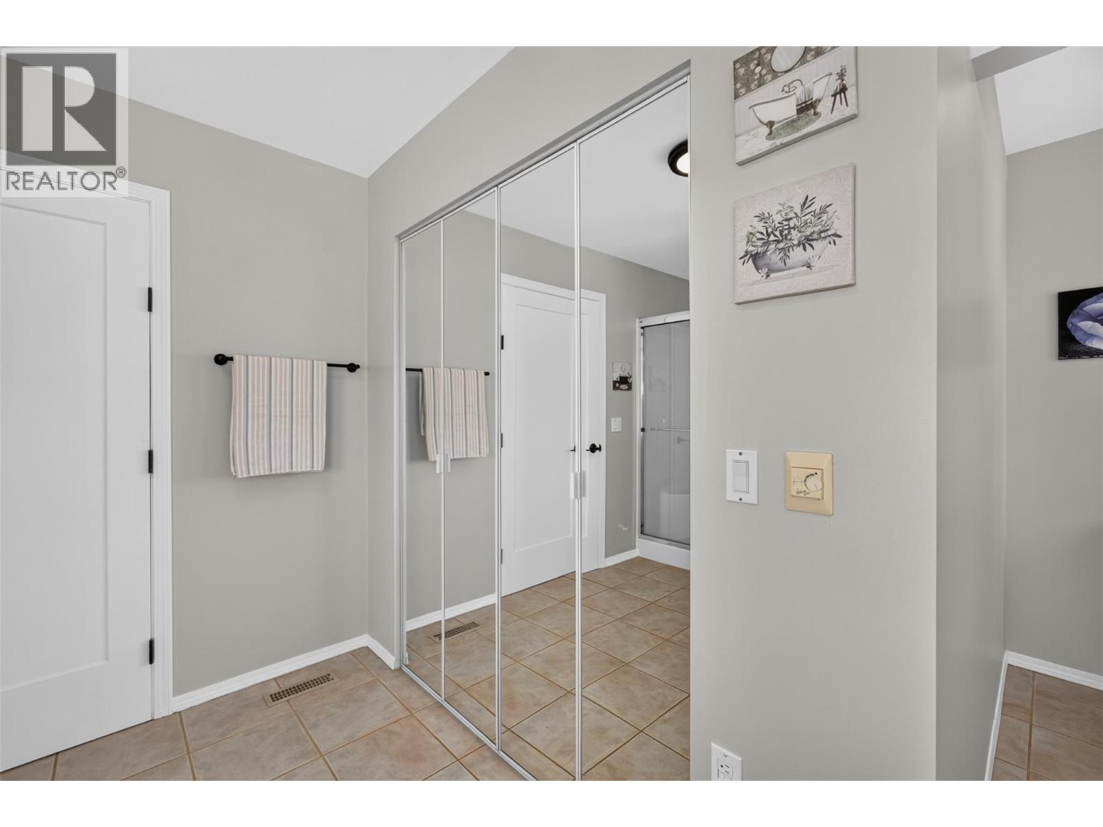Primary ensuite with soaker tub & a walk-in shower - 3491 Fenton Road, West Kelowna, BC - Indoor Photo Showing Bedroom