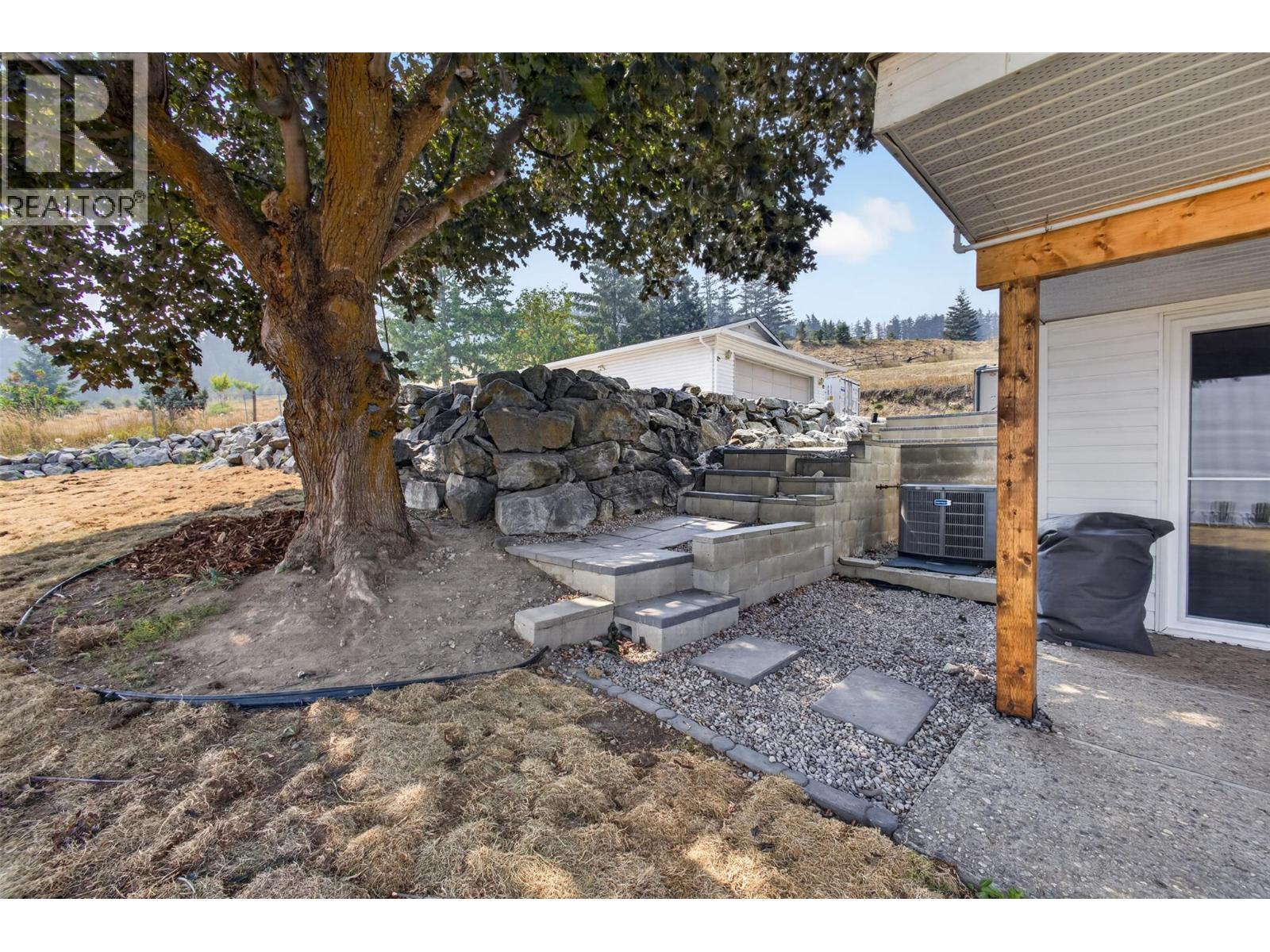 Steps down to the lower level entrance - 3491 Fenton Road, West Kelowna, BC - Outdoor With Deck Patio Veranda With Exterior