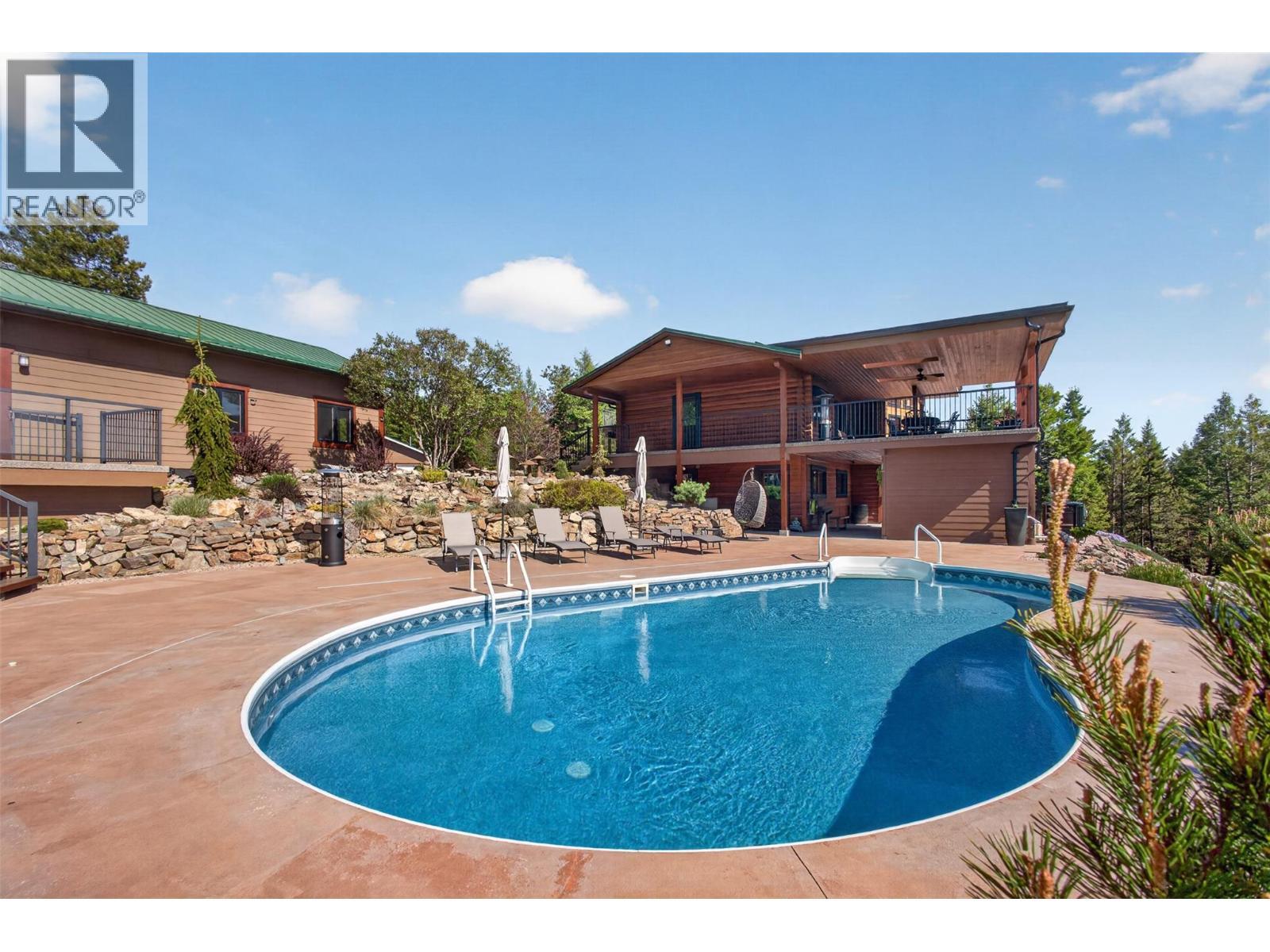 7319 Trapper Court, Kelowna, BC - Outdoor With In Ground Pool With Deck Patio Veranda
