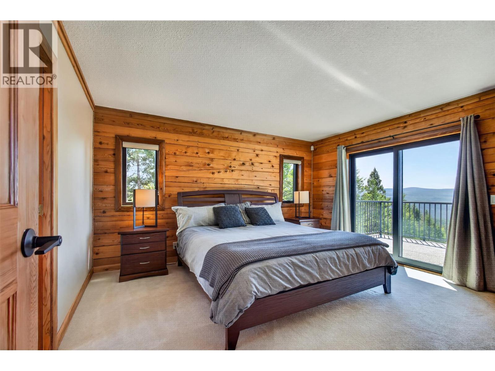Primary bedroom with an additional entrance to the patio - 7319 Trapper Court, Kelowna, BC - Indoor Photo Showing Bedroom