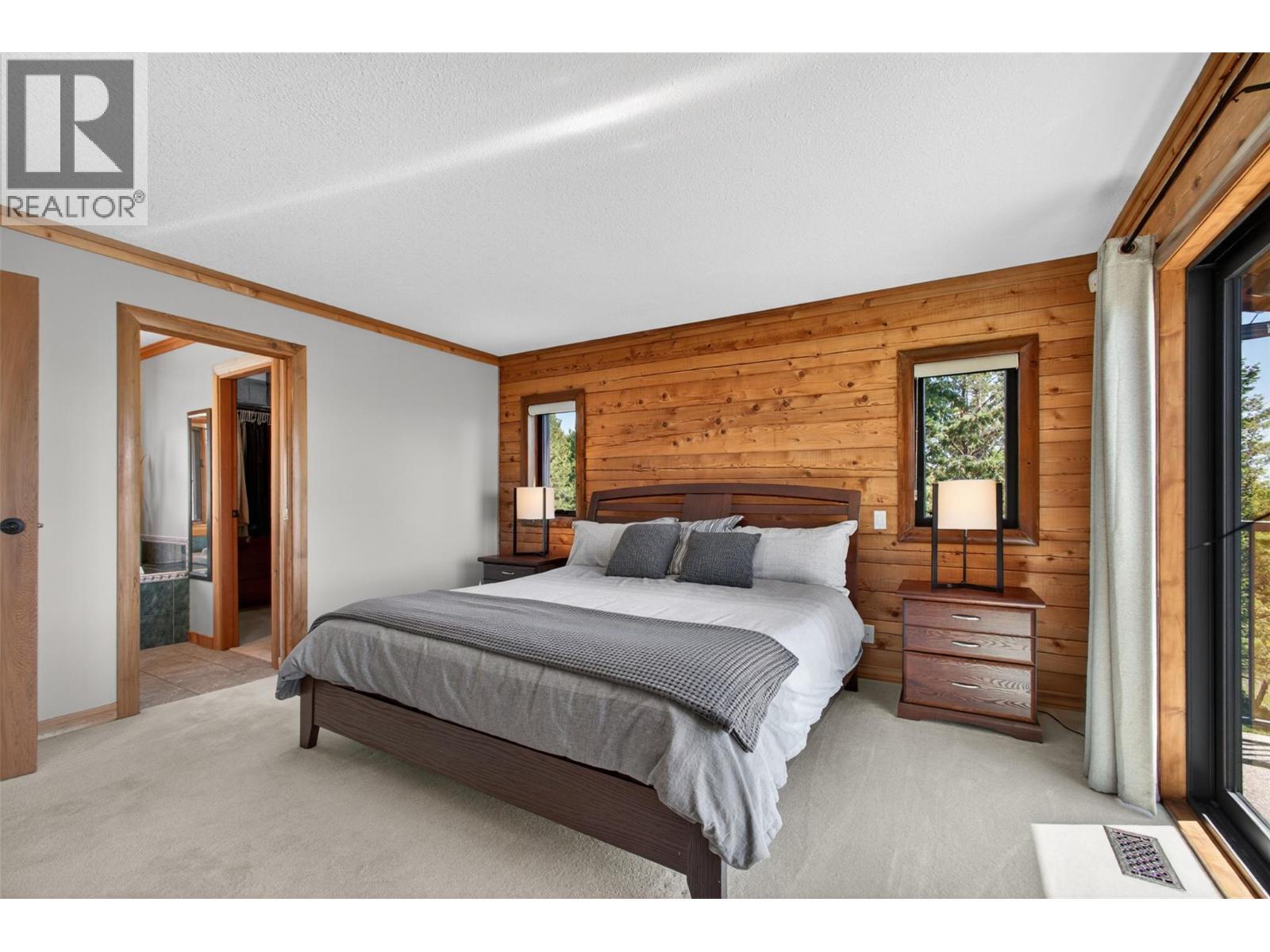 Primary bedroom with an additional entrance to the patio - 7319 Trapper Court, Kelowna, BC - Indoor Photo Showing Bedroom