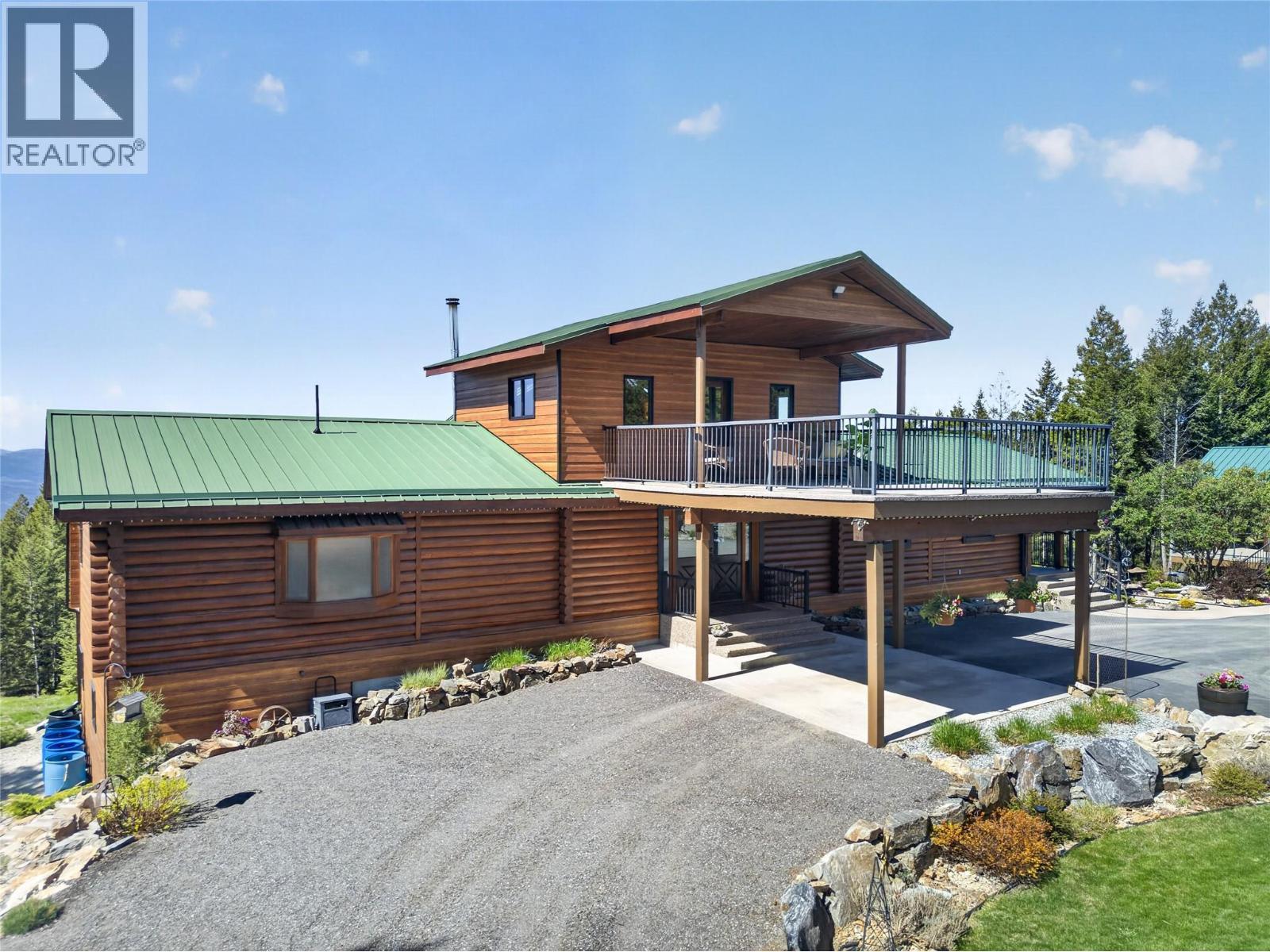 Home is a stunning log cabin - 7319 Trapper Court, Kelowna, BC - Outdoor With Deck Patio Veranda