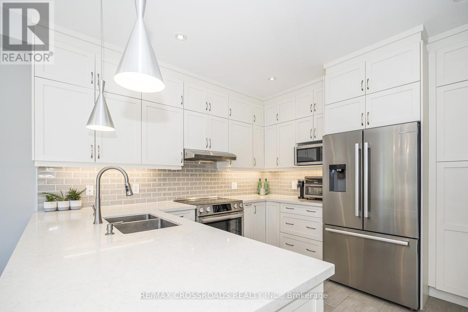 Stylish Backsplash and Valance Lighting - 21A Brian Drive, Toronto, ON - Indoor Photo Showing Kitchen With Double Sink With Upgraded Kitchen