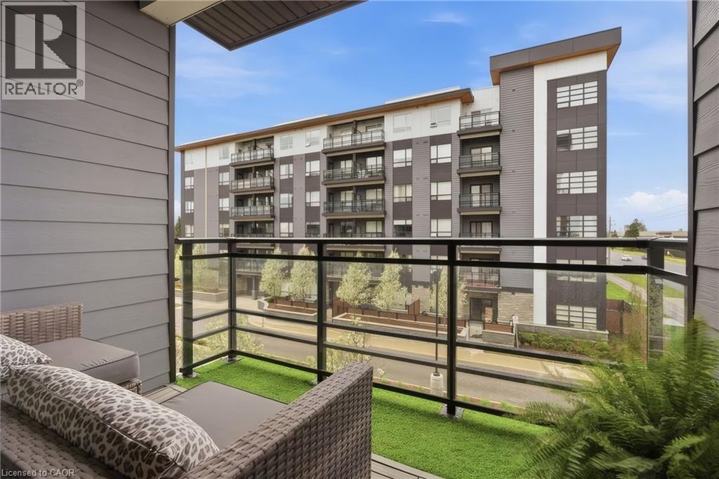 Balcony with glass railing and artificial turf - 251 Northfield Drive E Unit# 312, Waterloo, ON