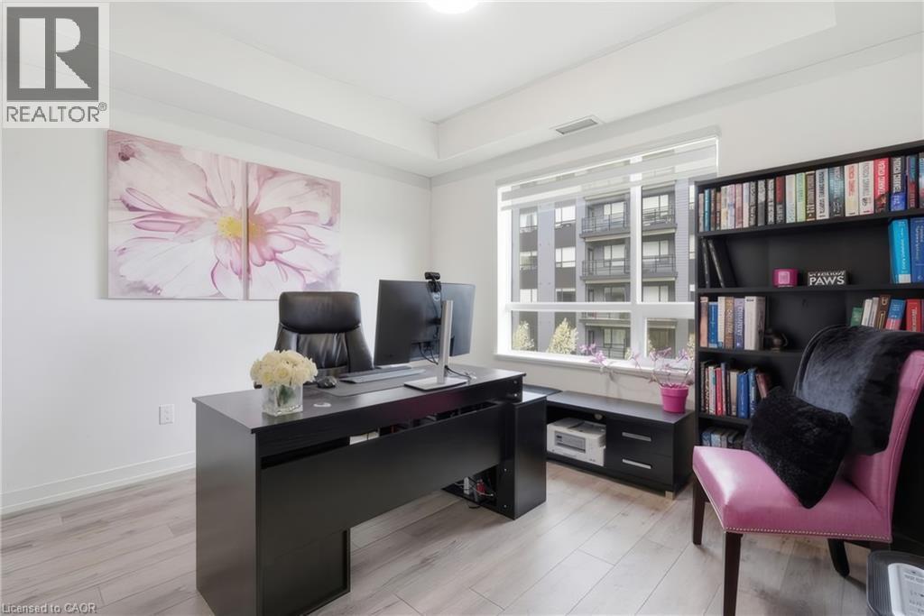 Recessed lighting, wide window, light wood-finish flooring, built-in shelving, and crisp white walls - 251 Northfield Drive E Unit# 312, Waterloo, ON