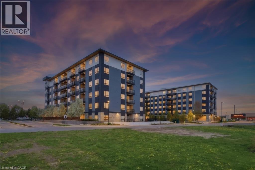 Modern building exterior with multiple balconies, dark grey and light grey paneling, and numerous windows - 251 Northfield Drive E Unit# 312, Waterloo, ON