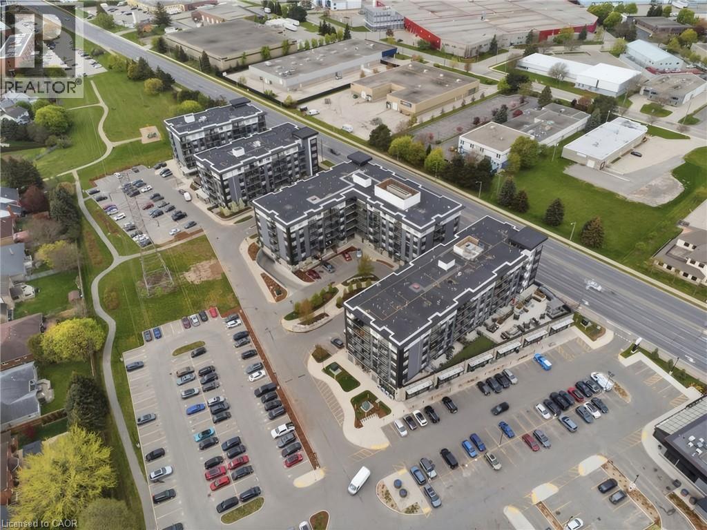Modern multi-story buildings featuring dark exterior cladding and light-colored trim - 251 Northfield Drive E Unit# 312, Waterloo, ON