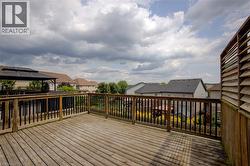 Expansive wood deck with a privacy screen and black spindle railings - 
