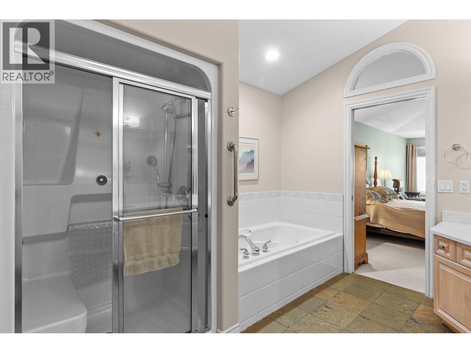 Shower and bathtub ensuite. - 4400 Gallaghers Drive E Unit# 2, Kelowna, BC - Indoor Photo Showing Bathroom