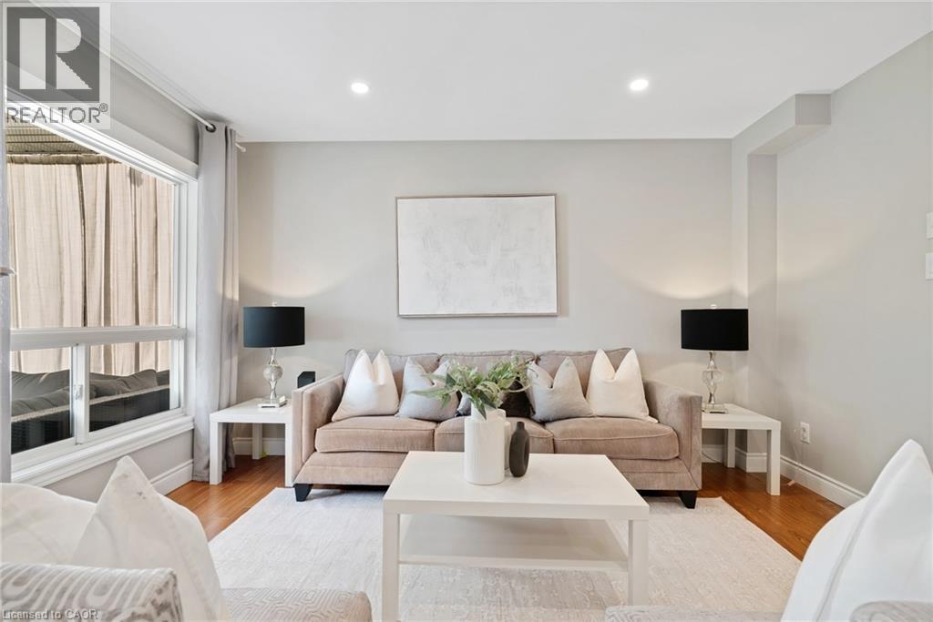 Recessed lighting, wood-finish flooring, and a large window with white trim - 711 Angler Way, Waterloo, ON - Indoor Photo Showing Living Room
