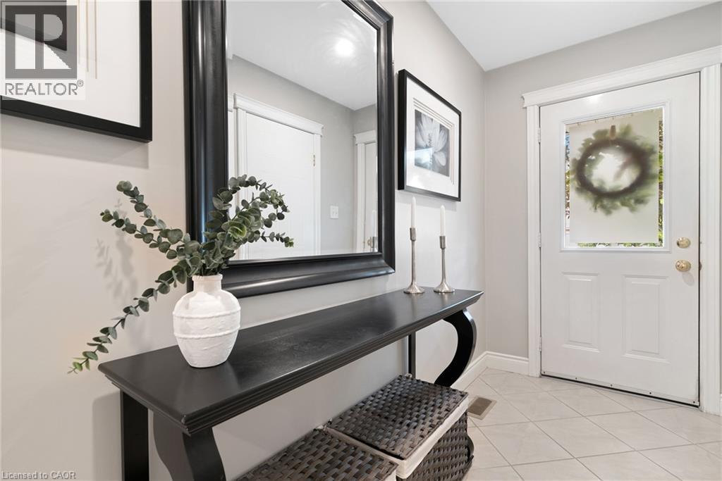 White paneled door with frosted glass insert, neutral wall paint, and tiled flooring - 711 Angler Way, Waterloo, ON - Indoor Photo Showing Other Room