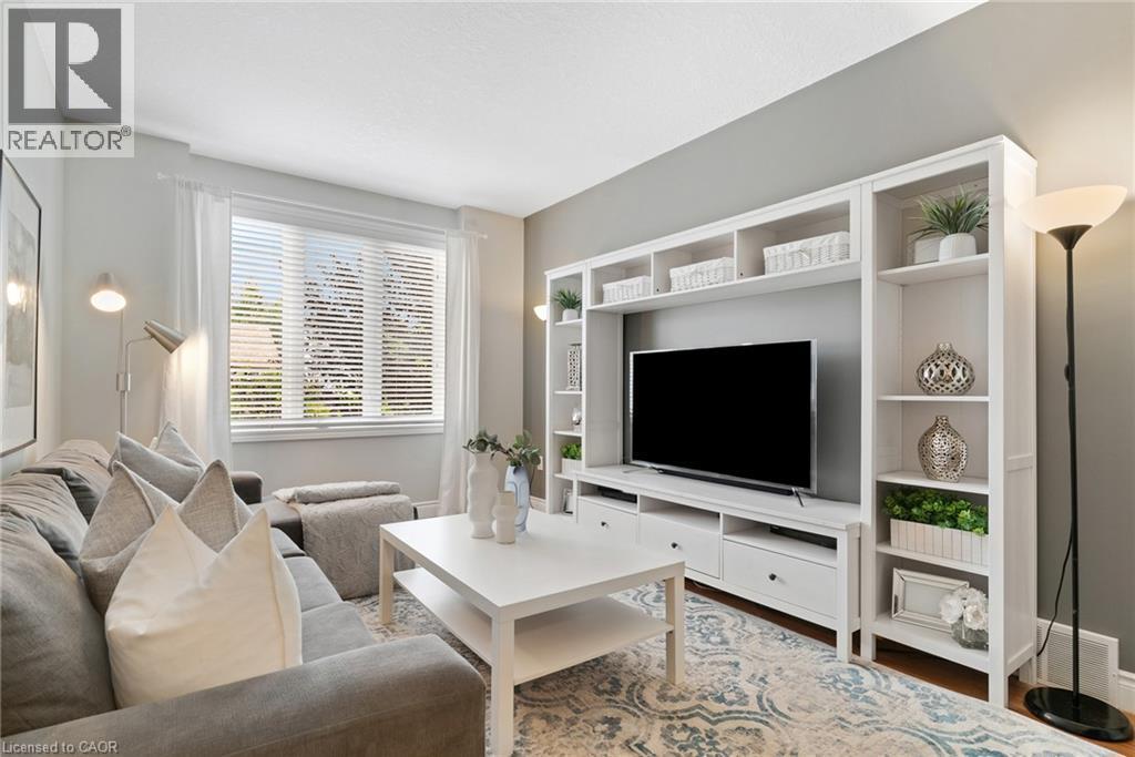 Expansive window with blinds and sheer drapery - 711 Angler Way, Waterloo, ON - Indoor Photo Showing Living Room
