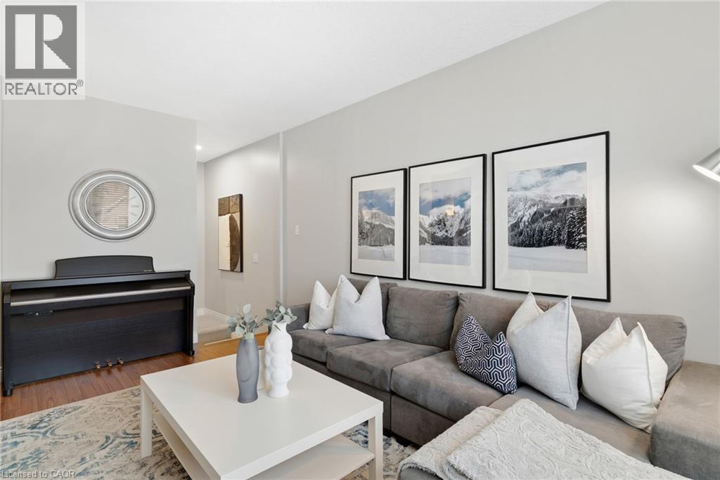 Light gray wall paint, recessed lighting, wood-finish flooring, and a white ceiling - 711 Angler Way, Waterloo, ON - Indoor Photo Showing Living Room