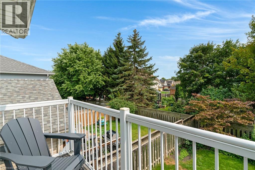 Balcony with white railing, wood-shingle roof, and mature perimeter trees - 711 Angler Way, Waterloo, ON - Outdoor