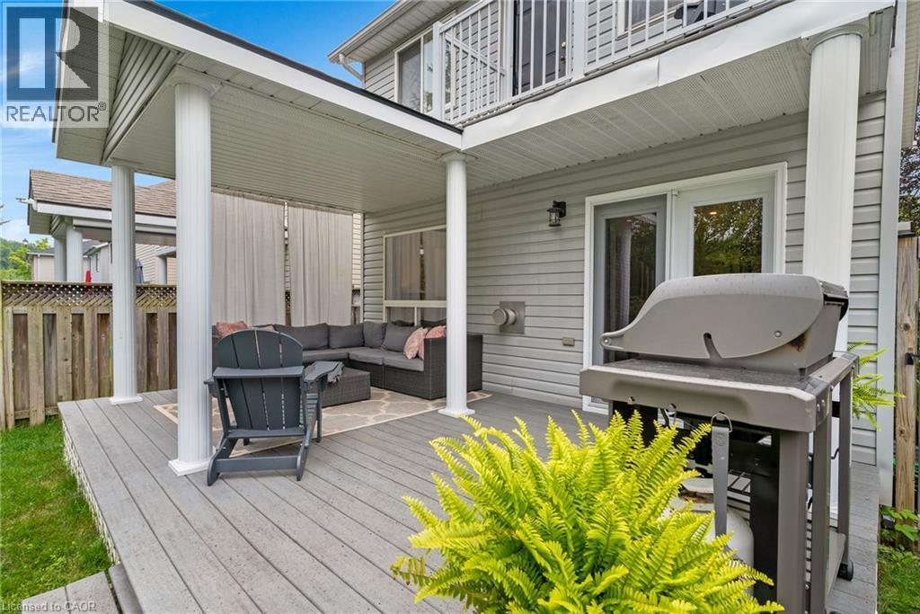 Expansive covered deck featuring a textured surface, multiple support columns, and privacy screens - 711 Angler Way, Waterloo, ON - Outdoor With Deck Patio Veranda With Exterior