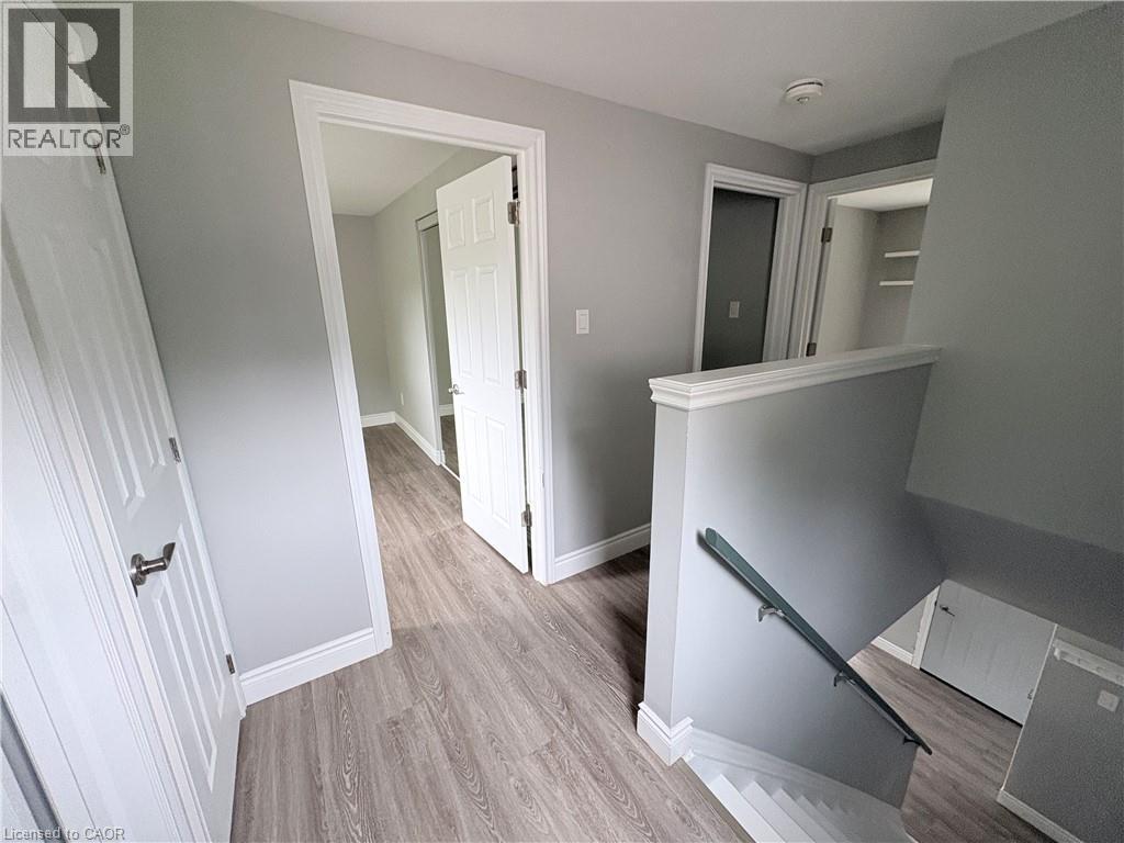 Wood-finish flooring throughout, with white trim and doors - 216 Brunswick Crescent, London, ON