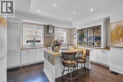 A view into the kitchen featuring a built-in display cabinet and built-in Fisher & Paykel refrigerator. - 
