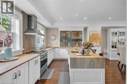 Stainless Fisher & Paykel gas range with built-in Fisher & Paykel double dishwasher drawers in the island. - 