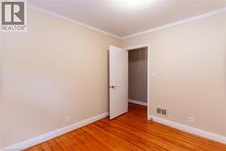 Interior room featuring wood-finish flooring and neutral wall tones - 