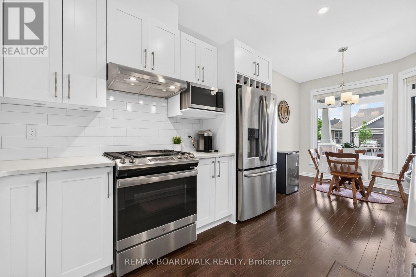 Under Valance Lighting + Subway Tile Backsplash - 224 Maygrass Way, Ottawa, ON - Indoor Photo Showing Kitchen With Upgraded Kitchen