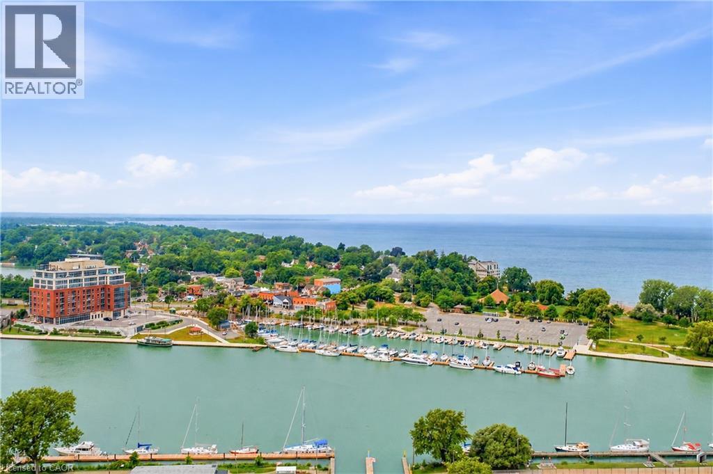 Aerial perspective showcasing a vibrant waterfront community with a marina, body of water, and surrounding greenery - 11 Kimbermount Drive, St. Catharines, ON - Outdoor With Body Of Water With View