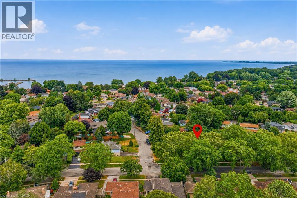 Aerial perspective showcasing a residential area with dense tree coverage and broad water frontage - 11 Kimbermount Drive, St. Catharines, ON - Outdoor With Body Of Water With View