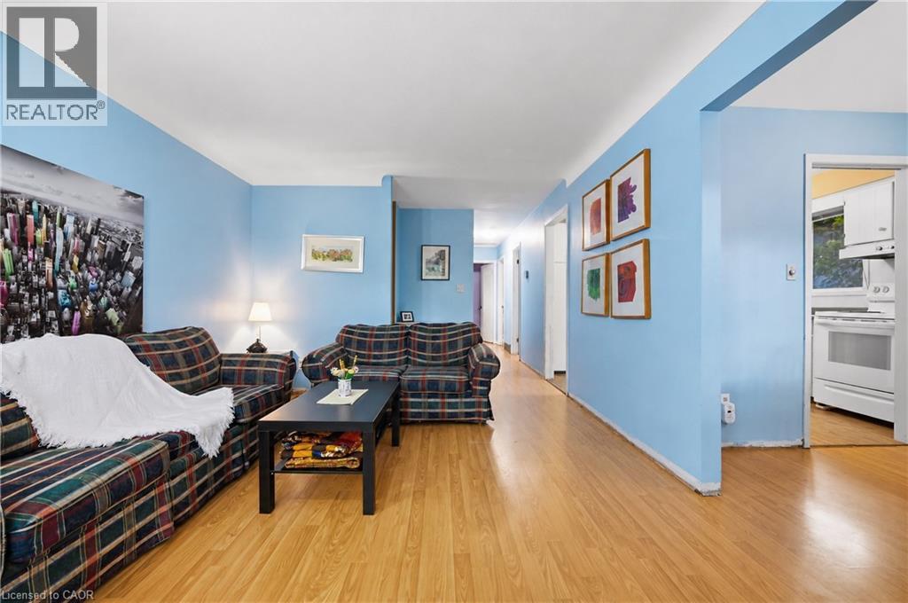 Living area featuring wood-finish flooring, light blue walls, and a recessed doorway - 11 Kimbermount Drive, St. Catharines, ON - Indoor Photo Showing Living Room