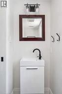 White floating vanity with integrated sink and matte black faucet -