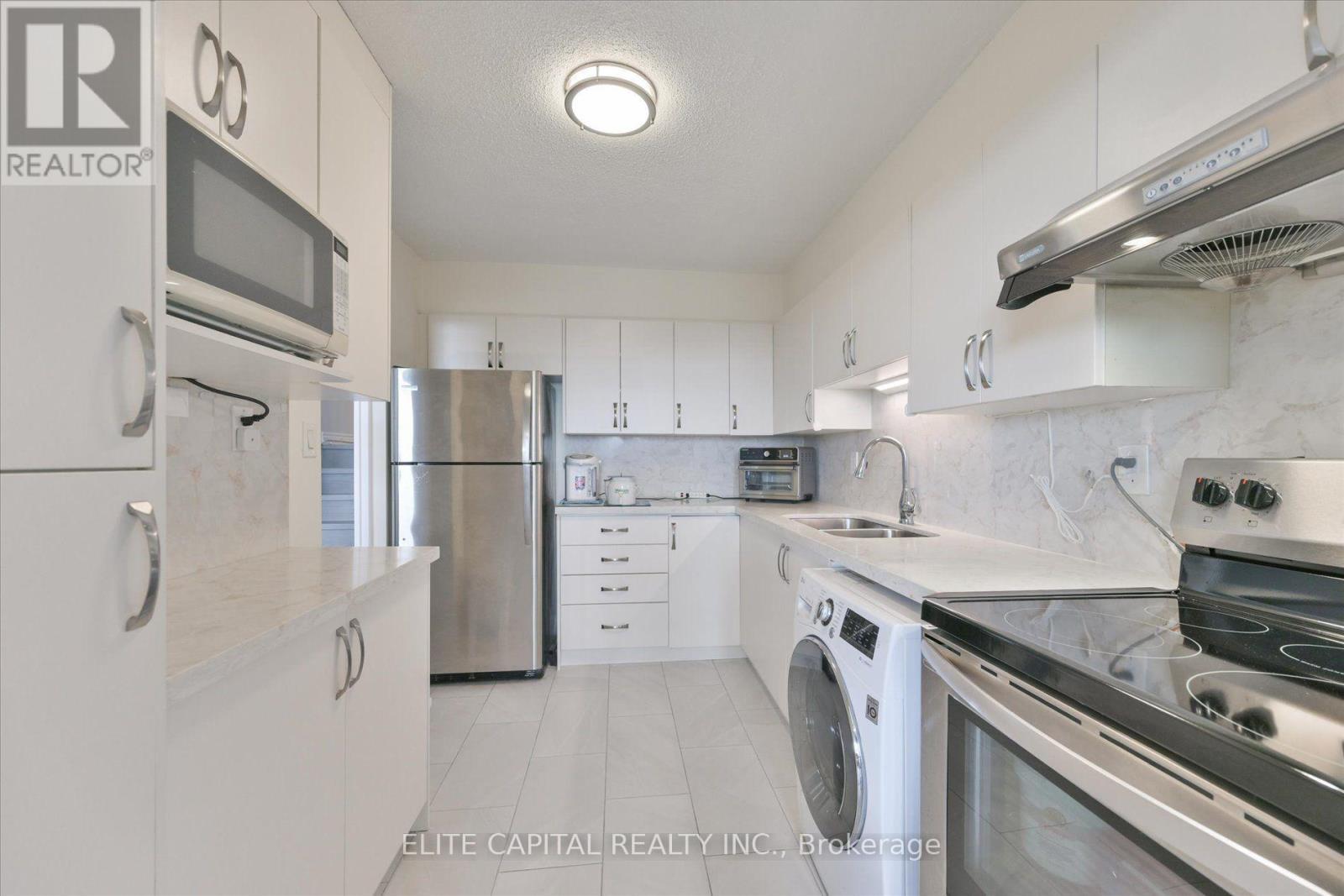 #1710 - 11 Wincott Drive, Toronto, ON - Indoor Photo Showing Kitchen With Double Sink