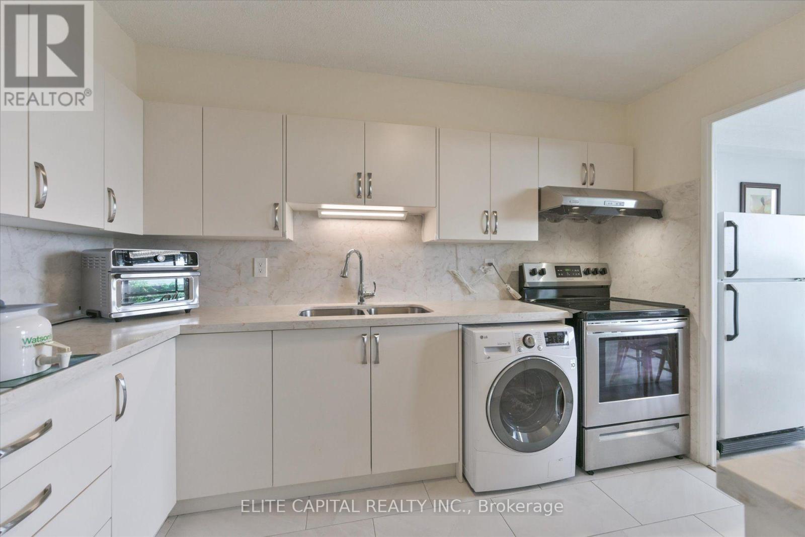 #1710 - 11 Wincott Drive, Toronto, ON - Indoor Photo Showing Kitchen With Double Sink