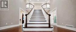 Grand Hardwood Staircase Leads to the Upper Level - 