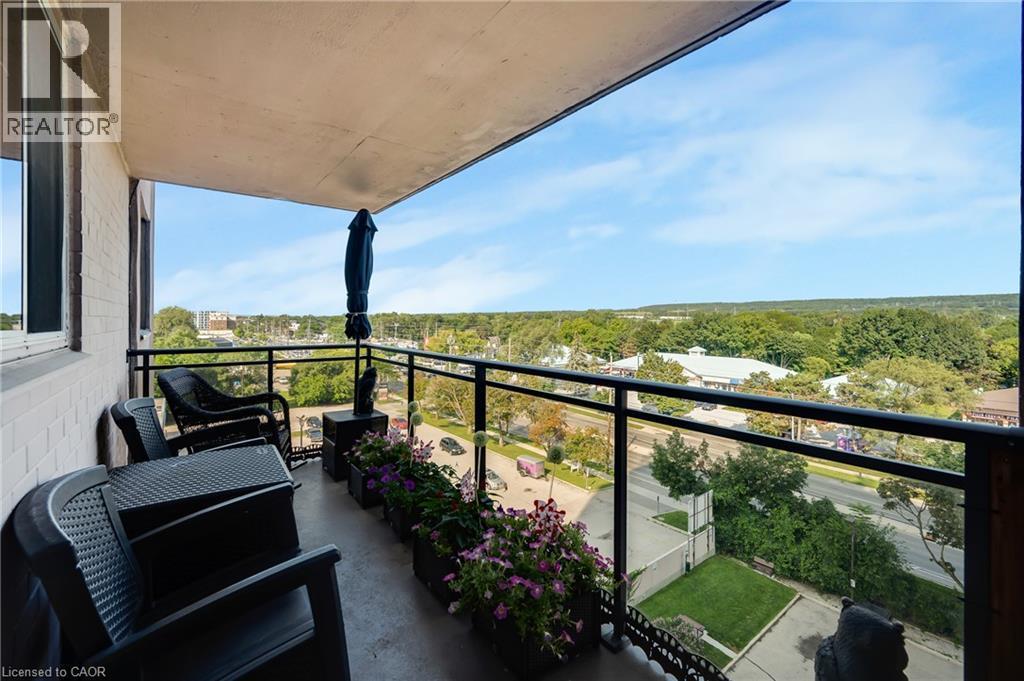 Balcony featuring a glass panel railing, concrete flooring, and a painted ceiling - 975 Warwick Court Unit# 708, Burlington, ON - Outdoor With Balcony With View With Exterior
