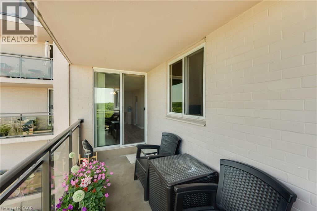Outdoor balcony with concrete flooring, glass railing, sliding patio door, and a permanent window - 975 Warwick Court Unit# 708, Burlington, ON - Outdoor With Exterior