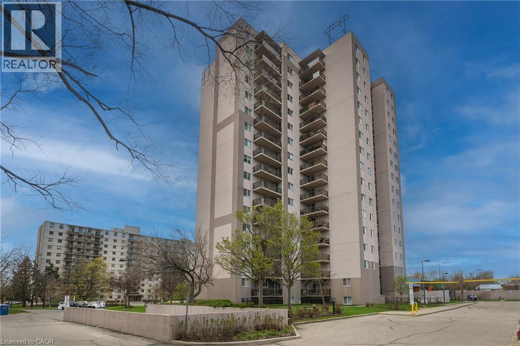 Multi-story building featuring multiple balconies, a structured facade, and surrounding landscaping - 975 Warwick Court Unit# 708, Burlington, ON - Outdoor With Balcony With Facade